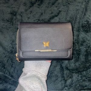 Small black purse with gold butterfly detailing.